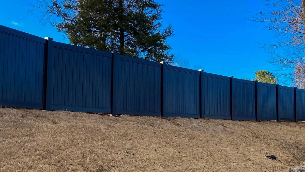 A black commercial aluminum fence along the length of a property’s driveway. First Step Fence offers commercial aluminum fence installation to the greater Richmond Virginia area.