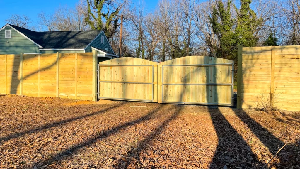 A residential wood fence with custom gates and panels. First Step Fence offers fully customizable wood fencing designs for any property.