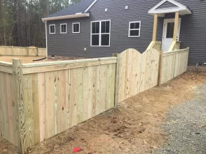 A 4 foot tall cap and trim wood privacy fence.