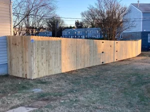 A 6 foot tall dog ear wood privacy fence.