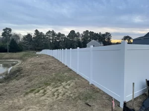 A 6 foot tall stock vinyl privacy fence.