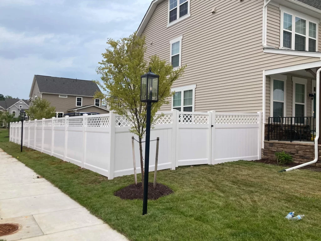 A 6 foot tall lattice top vinyl privacy fence.