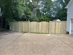 A 6 foot tall cap and trim wood privacy fence.